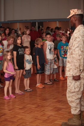 Cpl. James K. Spencer, an operations chief with Marine Corps University, Marine Corps Base Quantico, Va., and Fayetteville, N.C., native, calls children to attention during a National Museum of the Marine Corps educational outreach program at the John A. Polonye Community Center in Brook Park, Ohio, June 11. The program, part of Marine Week Cleveland June 11-17, featured a puppet show and a presentation by Marines in various time-period uniforms.