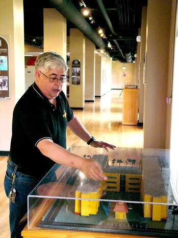 Depot command museum exhibit specialist Chuck Archuleta points out some of the details he has included in an exhibit featuring the depot’s recruit training barracks. Archuleta uses skills with tools that he learned growing up on his father’s Colorado ranch, to fabricate the displays and display cases found throughout the museum.