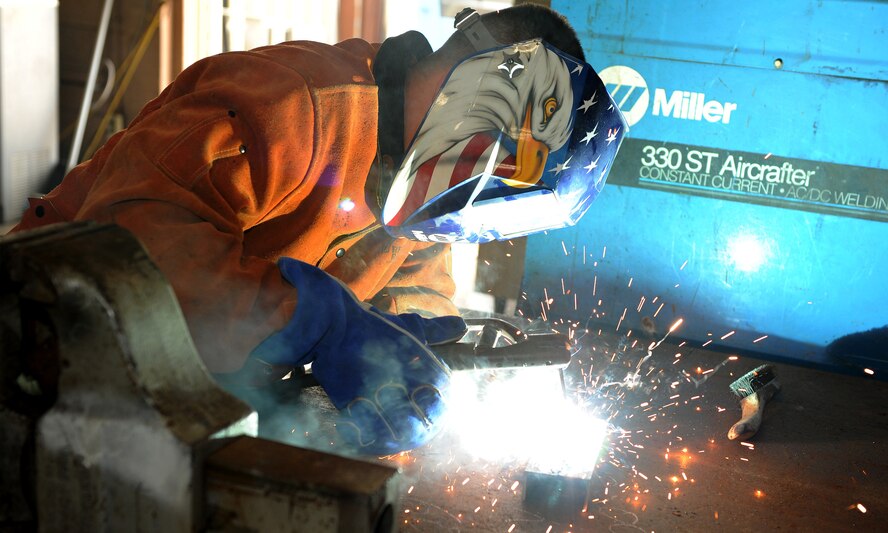 Senior Airman Matthew Hochstein, 18th Civil Engineer Squadron, welds at the metal fabrication shop on Kadena Air Base, Japan, June 11, 2012. There are 10 military and 20 local national workers at the shop. The metal fabrication shop does many things, such as welding, sheet metal duct work and oxyacetylene cutting to support the 18th CES mission. (U.S. Air Force photo/Junko Kinjo)