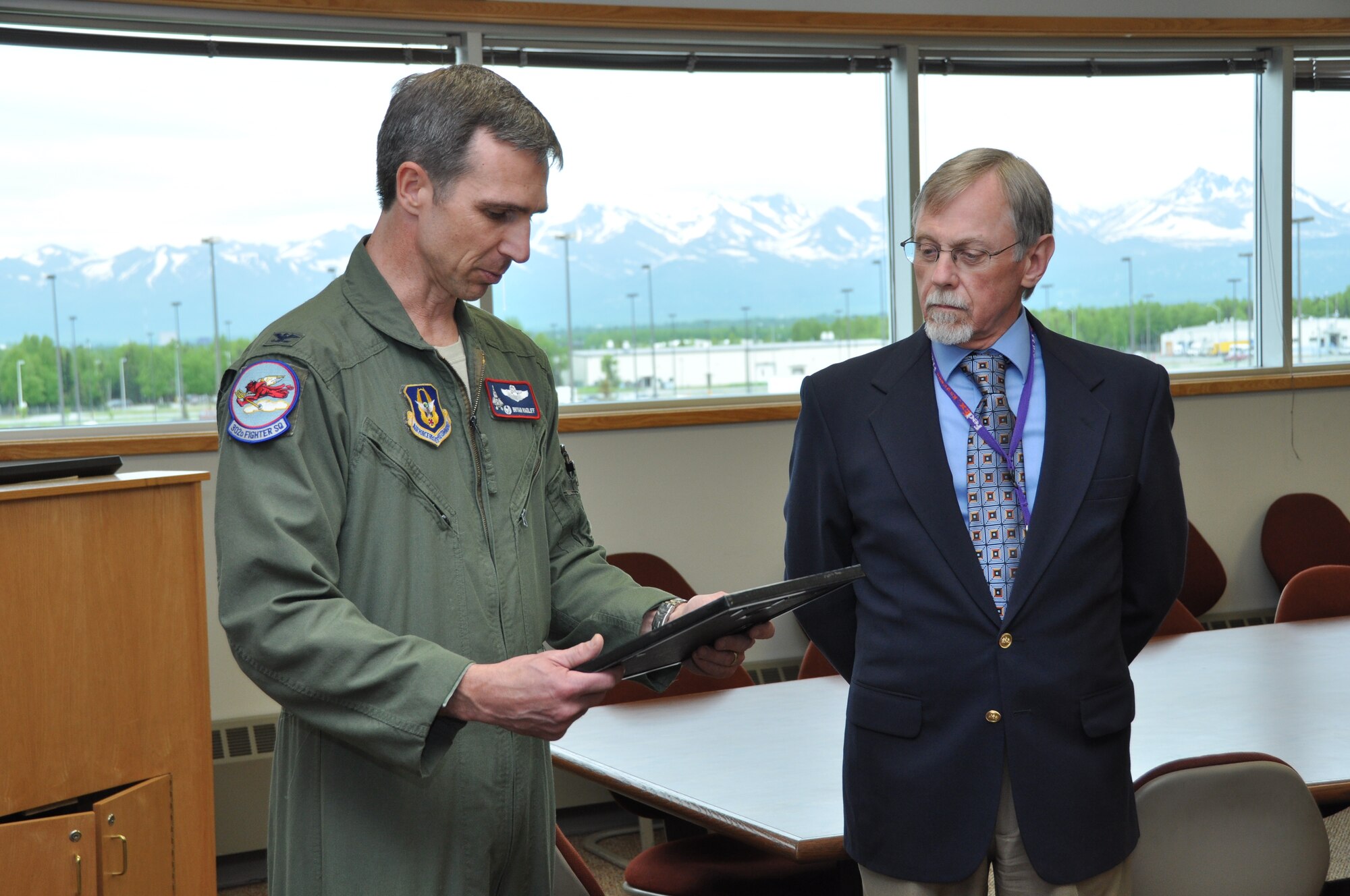 Col. Bryan Radliff, 477th Fighter Group commander, presents Robert Maxell, FedEx Operations manager, with ESGR’s Above and Beyond award on behalf of FedEx Anchorage Operations for the company-wide support of Guard and Reserve members employed by FedEx. (U.S. Air Force Photo/ Capt. Ashley Conner)