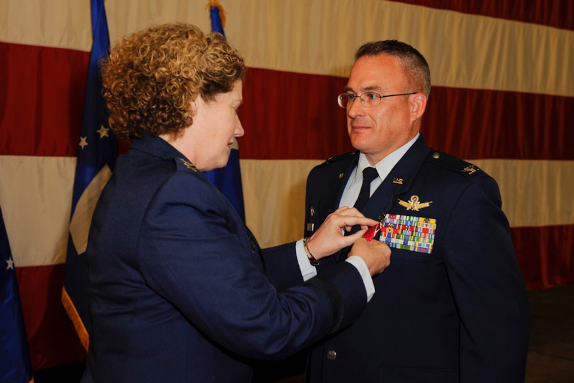 Col. Christopher Moss receives the Legion of Merit from Lt. Gen. Susan Helms, commander of U.S. Strategic Command's Joint Functional Component Command for Space and 14th Air Force (Air Forces Strategic), prior to relinquishing command of the 614th Air and Space Operations Center at Vandenberg Air Force Base, Calif. Moss took command of the 614th AOC on April 26, 2010. Helms praised Moss on his leadership over the past two years and the critical roles the 614th AOC played in the delivery of space effects supporting Operations Enduring Freedom, Iraqi Freedom, Tomodachi, Odyssey Dawn, and New Dawn. Regarding space situational awareness data sharing, the general said Moss solidified relationships with 32 commercial companies representing 12 different countries from around the globe. During his next assignment Moss will serve on the Pentagon's Joint Staff in the J3 directorate. (U.S. Air Force photo/Staff Sgt Levi Riendeau)