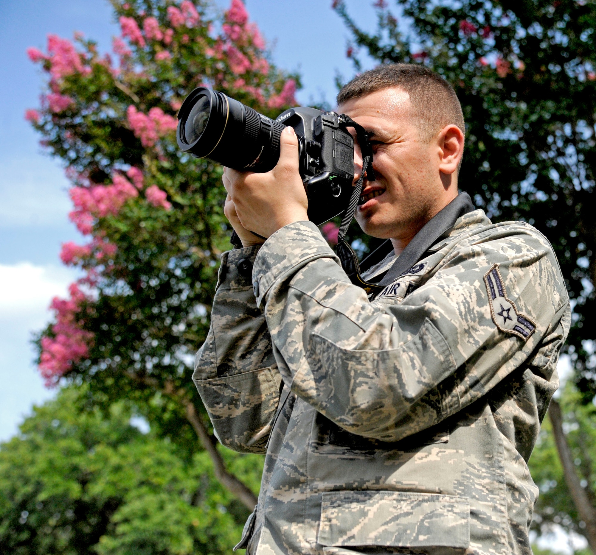 A 2nd Bomb Wing Public Affairs photojournalist documents a location job on Barksdale Air Force Base, La., June 8. Public Affairs has nine photojournalists who each individually capture more than 500 photos per week of Team Barksdale people, events and activities. (U.S. Air Force photo/Airman 1st Class Tory Groschick)(RELEASED)