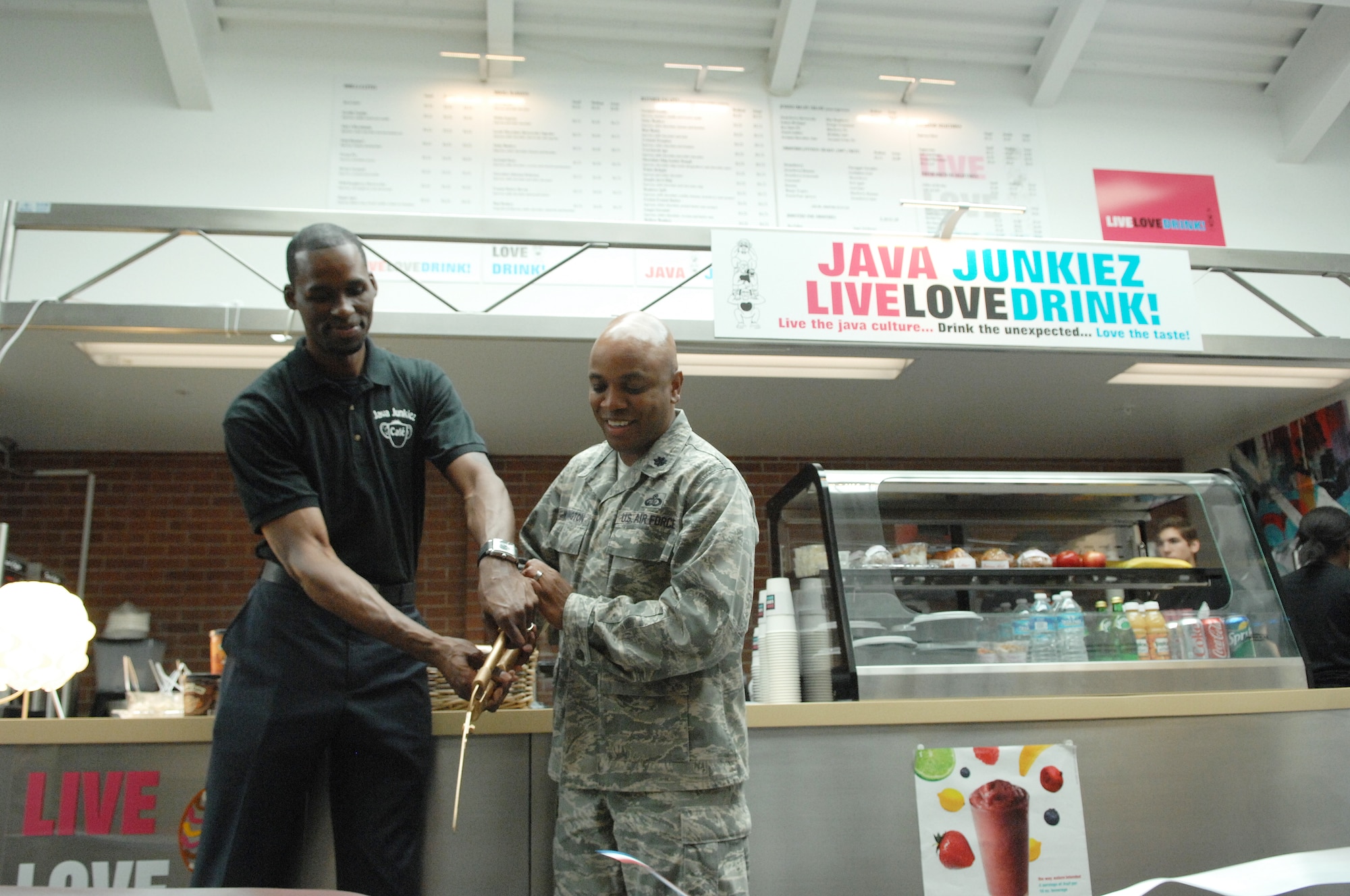 U.S. Air Force Lt. Col. Dalian Washington, 20th Force Support Squadron commander and Hardy Flowers, co-owner of Java Junkiez, cut the grand opening ribbon at the fitness center, Shaw Air Force Base, S.C., June 7, 2012.  Some of the profits from Java Junkiez will go towards the morale and wellness fund for Team Shaw.(U.S. Air Force photo by Airman Nicole Sikorski/Released)