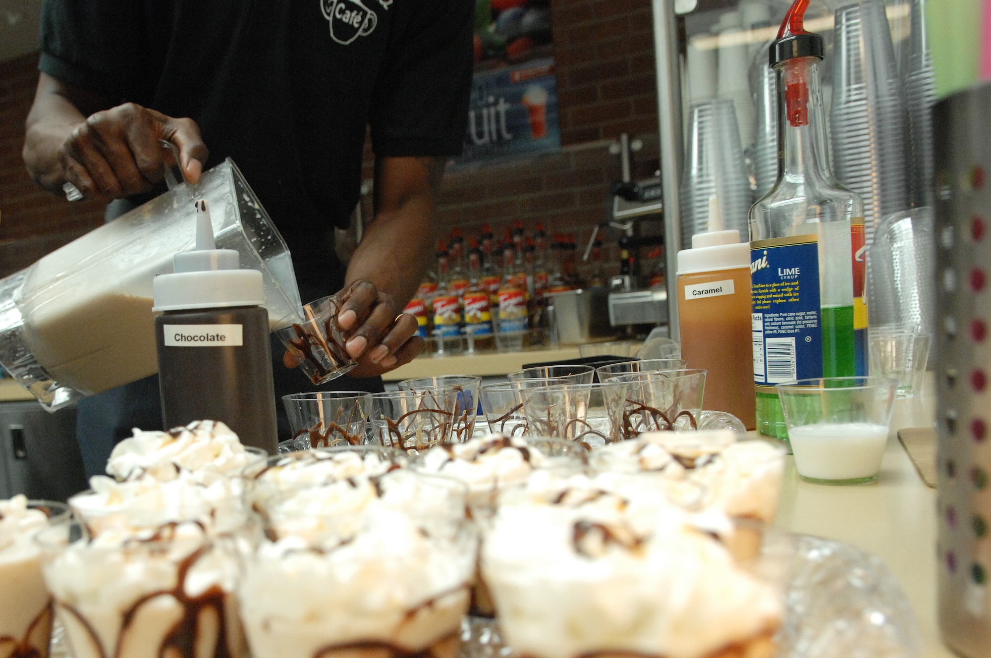 Hardy Flowers, co-owner of Java Junkiez, pours a Nutty Monkey smoothie into sample cups for the grand opening at the fitness center, Shaw Air Force Base, S.C., June 7, 2012.  Flowers and his wife Christy founded the company in 2004 and currently have three other locations.(U.S. Air Force photo by Airman Nicole Sikorski/Released)