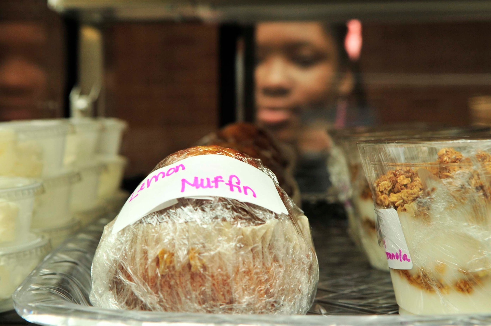 Tara Huckleby, Java Junkiez worker, fills the refrigerated cabinet with muffins as Java Junkiez prepares for its grand opening at the fitness center, Shaw Air Force Base, S.C., June 7, 2012.  Java Junkiez, founded by Hardy and Christy Flowers in 2004, also has locations in Pensacola,  Fla.; Baltimore, Md.; and Maxwell Air Force Base, Ala. Some of the profits from Java Junkiez will be returned to the morale and welfare fund for Team Shaw.(U.S. Air Force photo by Airman Nicole Sikorski/Released)