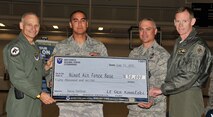 MINOT AIR FORCE BASE, N.D. -- Lt. Gen. James Kowalski, Air Force Global Strike commander, presents Team Minot leadership with a $50,000 check at the McAdoo Sports and Fitness Center June 11. The quality of life funds came as a reward to Team Minot Airmen for placing first in the base category for most meters rowed during last month’s AFGSC Rowing Challenge. (U.S. Air Force photo/Airman 1st Class Andrew Crawford)