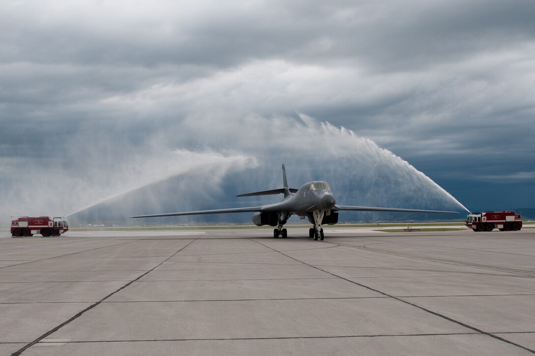 A B-1 piloted by Col. Steven Hiss, 28th Bomb Wing vice commander, taxis under arcs of water after Hiss’ final flight at Ellsworth Air Force Base, S.D., June 7, 2012. In keeping with tradition, Hiss’ spouse, children, and crew members were on hand following the flight with a fire hose to ensure he was soaked from head to toe, celebrating and thanking Him for his dedication and service to Ellsworth. (U.S. Air Force photo by Airman 1st Class Kate Thornton/Released)