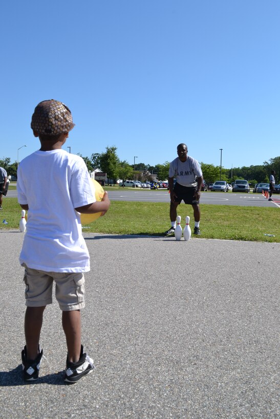 U.S. Army Pfc. Jamal Young, 59th Inland Cargo Transfer Company, 10th Transportation Battalion, 7th Sustainment Brigade, waits for a student to kick the ball towards the pins during General Stanford Elementary School's field day at Ft. Eustis, Va., June 7, 2012. The school has a field day at the end of each school year to allow the students a chance to enjoy themselves, stay active and encourage physical fitness. (U.S. Army photo by Spc. Ondirae H. Abdullah-Robinson/Released)