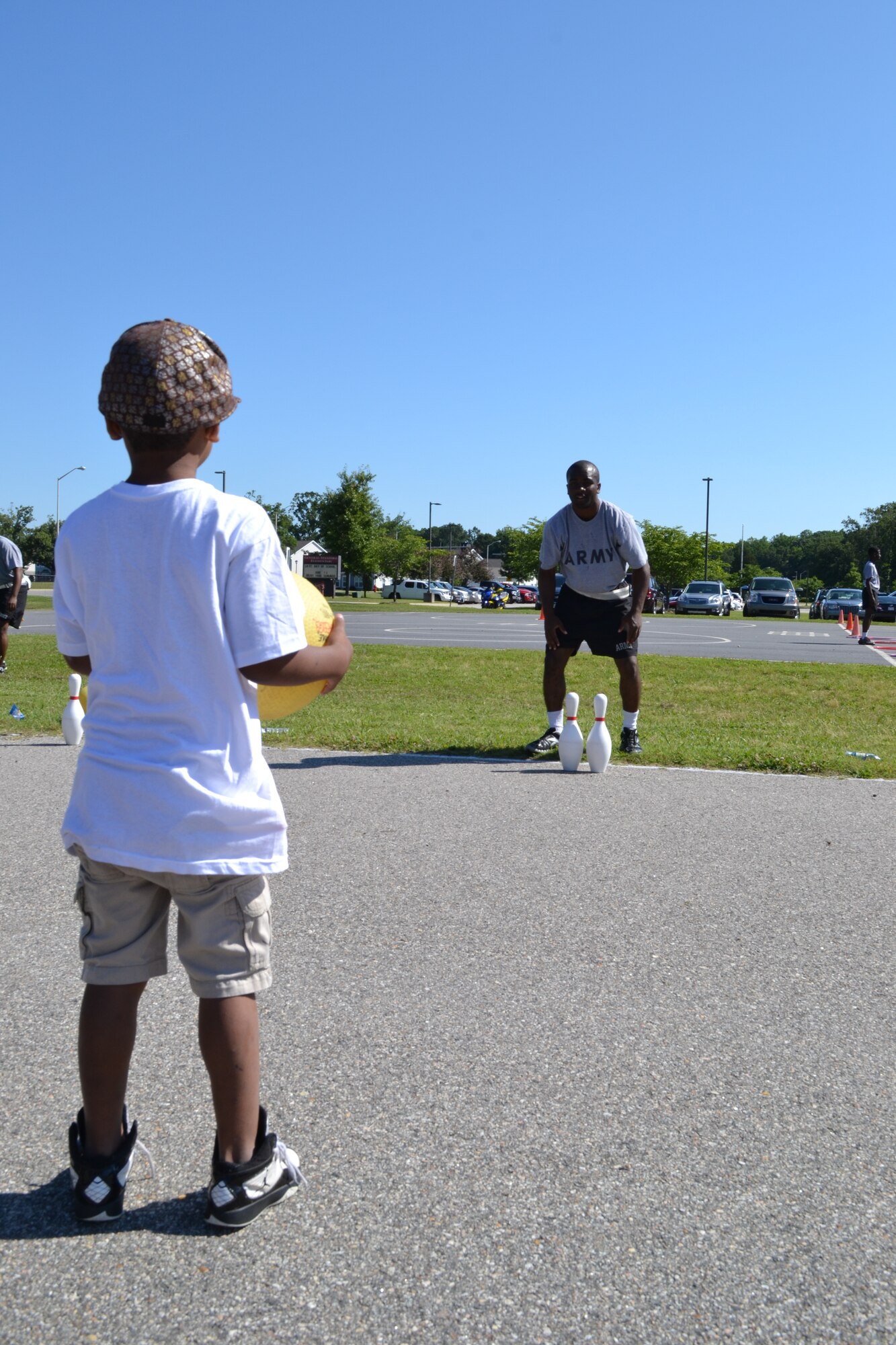 U.S. Army Pfc. Jamal Young, 59th Inland Cargo Transfer Company, 10th Transportation Battalion, 7th Sustainment Brigade, waits for a student to kick the ball towards the pins during General Stanford Elementary School's field day at Ft. Eustis, Va., June 7, 2012. The school has a field day at the end of each school year to allow the students a chance to enjoy themselves, stay active and encourage physical fitness. (U.S. Army photo by Spc. Ondirae H. Abdullah-Robinson/Released)