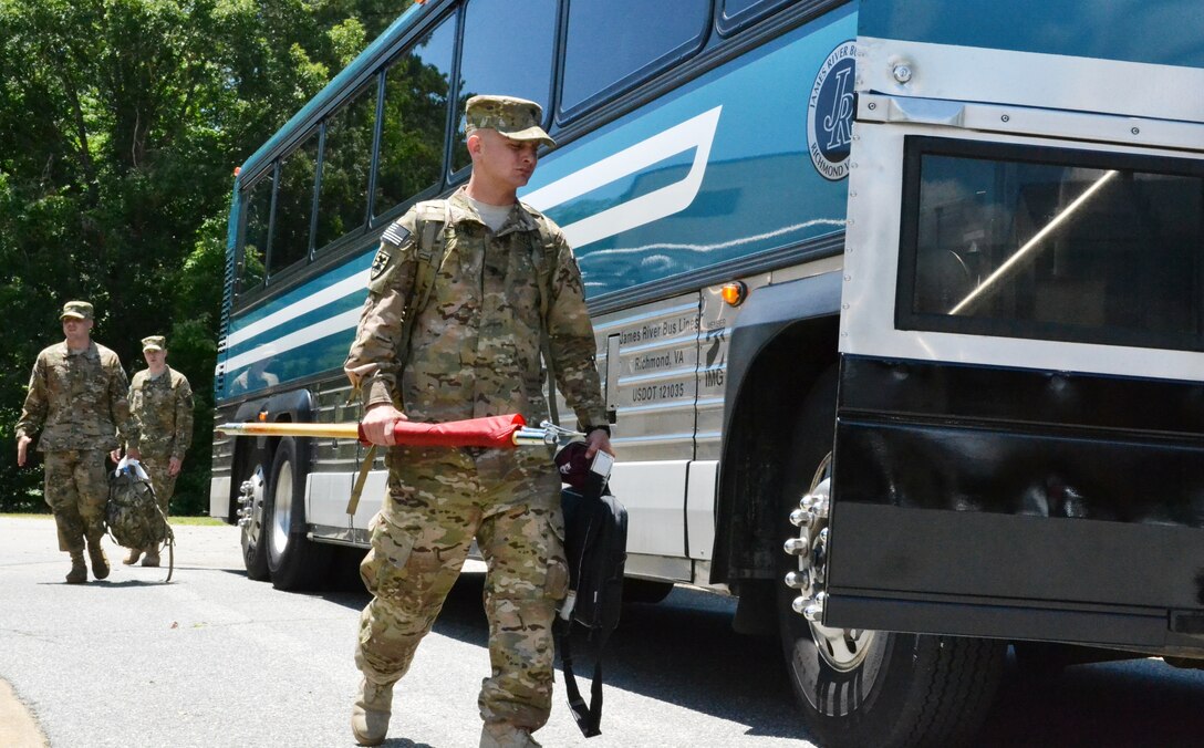 U.S. Army Spc.Donald Belisle, assigned to the 358th Automated Cargo Documentation Detachment, 10th Transportation Battalion, 7th Sustainment Brigade leads the way to the buses after the “Scan Devils” deployment ceremony at the McClellan Fitness Center at Ft. Eustis, Va., June 7, 2012. The “Scan Devils” will focus on troops coming back home as the Afghan Army takes over combat and sustainment operations in their country. (U.S. Army photo by Sgt. Edwin Rodriguez/Released)