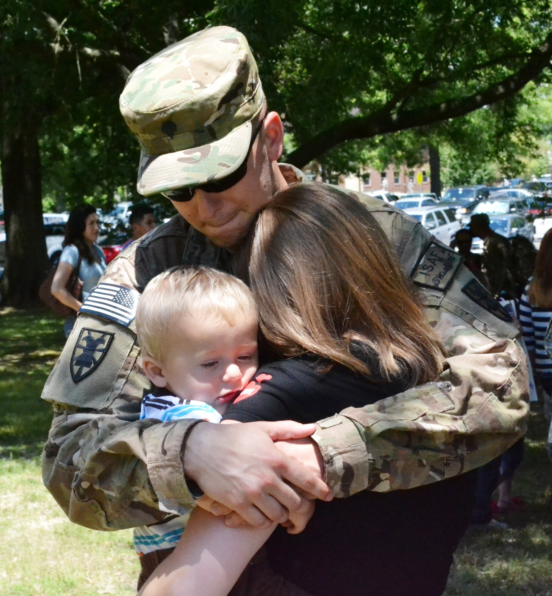 U.S. Army Spc. Daniel Hamilton, assigned to the 358th Automated Cargo Documentation Detachment, 10th Transportation Battalion, 7th Sustainment Brigade, hugs his family after the “Scan Devils” deployment ceremony at the McClellan Fitness Center at Ft. Eustis, Va., June 7, 2012. Twenty-one Soldiers from the 358th ACDD deployed to the northern region of Afghanistan in support of cargo operations and the documentation of movement in and out of country. (U.S. Army photo by Sgt. Edwin Rodriguez/Released)