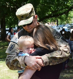 U.S. Army Spc. Daniel Hamilton, assigned to the 358th Automated Cargo Documentation Detachment, 10th Transportation Battalion, 7th Sustainment Brigade, hugs his family after the “Scan Devils” deployment ceremony at the McClellan Fitness Center at Ft. Eustis, Va., June 7, 2012. Twenty-one Soldiers from the 358th ACDD deployed to the northern region of Afghanistan in support of cargo operations and the documentation of movement in and out of country. (U.S. Army photo by Sgt. Edwin Rodriguez/Released)