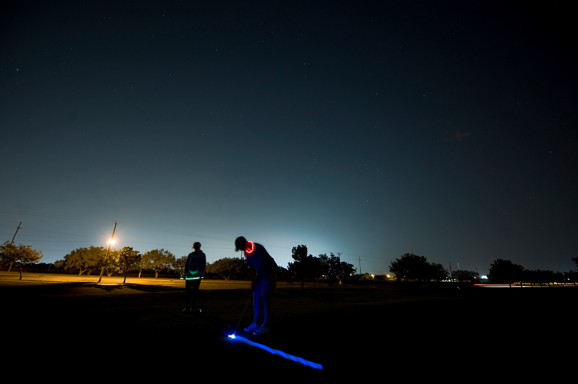 A participant in the Commander’s Farewell Golf Tournament putts a glow-in-the-dark ball toward the hole June 8, 2012, during the tournament at Dyess Air Force Base, Texas. Servicemembers throughout Dyess came out to Mesquite Grove Golf Course for the tournament. The participants played nine holes during the day and nine holes at night.  (U.S. Air Force photo by Airman 1st Class Damon Kasberg /Released)