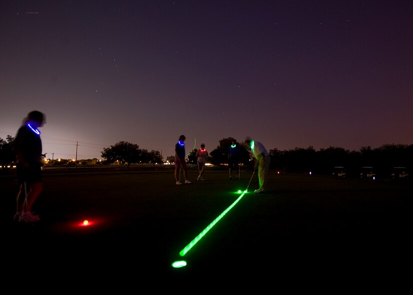 A participant in the Commander’s Farewell Golf Tournament putts a glow-in-the-dark ball toward the hole June 8, 2012, during the tournament at Dyess Air Force Base, Texas. Servicemembers throughout Dyess came out to Mesquite Grove Golf Course for the tournament. The participants played nine holes during the day and nine holes at night.  (U.S. Air Force photo by Airman 1st Class Damon Kasberg /Released)
