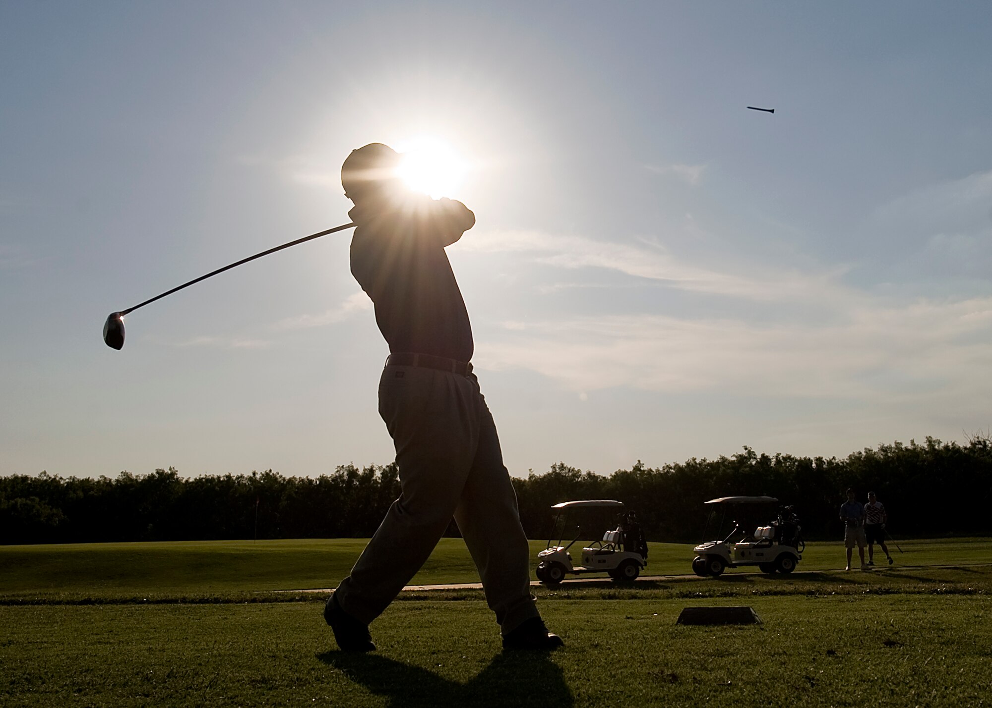 U.S. Air Force Lt. Col. Trevor Williams, 7th Comptroller Squadron commander, fallows through with his shot June 8, 2012, during the Commander’s Farewell Golf Tournament at Dyess Air Force Base, Texas. Servicemembers throughout Dyess came out to Mesquite Grove Golf Course for the tournament. The participants played nine holes during the day and nine holes at night.  (U.S. Air Force photo by Airman 1st Class Damon Kasberg /Released)