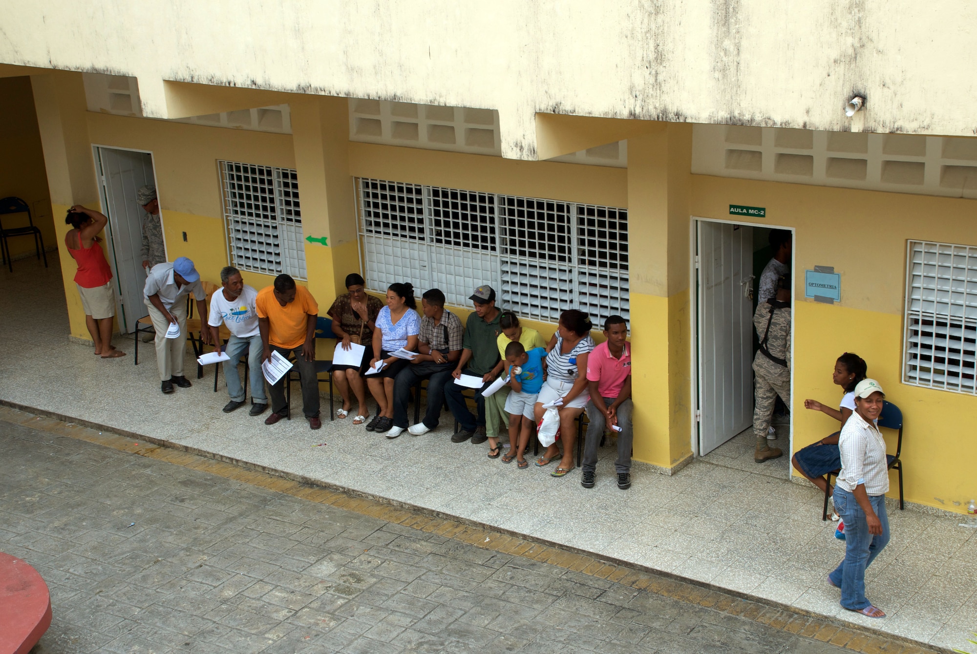 Patients wait to be seen at a temporary Optometry clinic housed in a local school in Puerto Plata, Dominican Republic. 944th medical Squadron members partnered with Reserve and Guard members from nine different units last month on a Medical Humanitarian mission to the Dominican Republic.  The 47 person U.S. team, made up of medical, dental, optometry and pharmacy personnel, provided care to more than 10,000 patients during their 15 day visit. (U.S. Air Force Photo by Maj. Alan Mirly) 