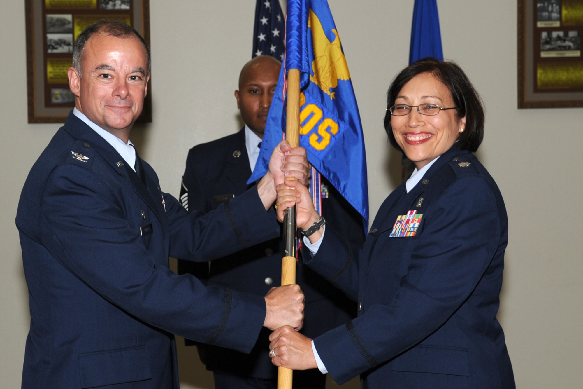 GOODFELLOW AIR FORCE BASE, Texas-- Col. James Forrest, 17th Medical Group Commander, passes the 17th Medical Operations Squadron  guidon to Lt. Col. Regina Agee during a change of command ceremony June 11. Agee was previously stationed at Randolph Air Force Base, Texas. (U.S. Air Force photo/Staff Sgt. Laura R. McFarlane)  