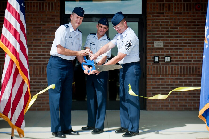 U.S. Air Force Col. Billy Thompson, 23d Wing commander, Col. Mark Ruse, 23d Mission Support Group commander, and Chief Master Sergeant Michael Goetz, 93d Air Ground Operations Wing command chief, cut the ribbon during a ceremony for the new 93d AGOW and 23d MSG headquarters building June 11, 2012, at Moody Air Force Base, Ga. With a total of 36,154 square feet, the facility also provides work areas for 23d WG exercises and plans, public affairs, base command post and equal opportunity offices. (U.S. Air Force photo by Staff Sgt. Jamal D. Sutter/Released) 
