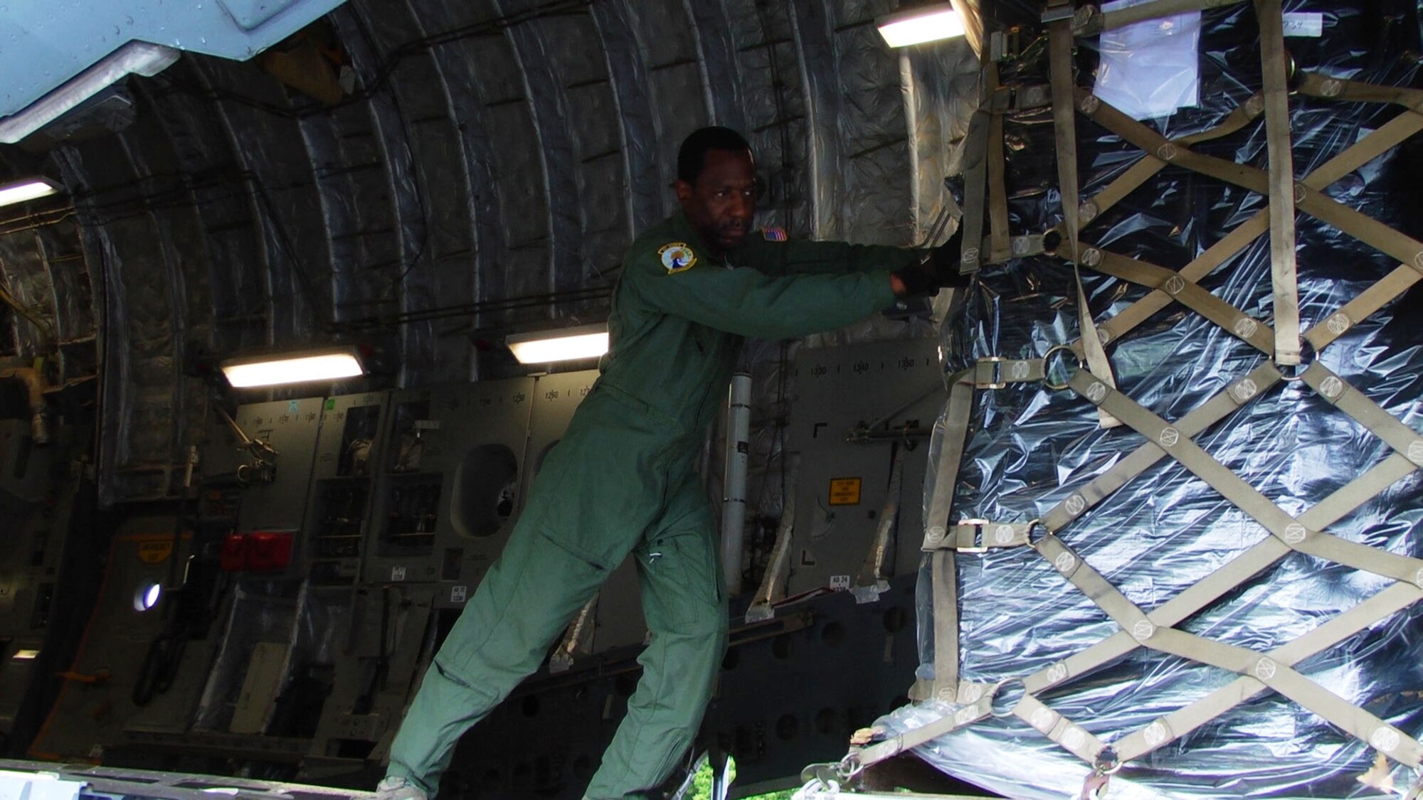 Master Sgt Bobby Barrett, a loadmaster with the 300th Airlift Squadron, offloads a pallet of humanitarian supplies in Managua, Nicaragua. This mission was made possible by the Denton Amendment, a State Department program allowing the delivery of donated humanitarian aid to fly on Air Force training missions on a space available basis. (Air Force Image by Lt. Joe Simms)