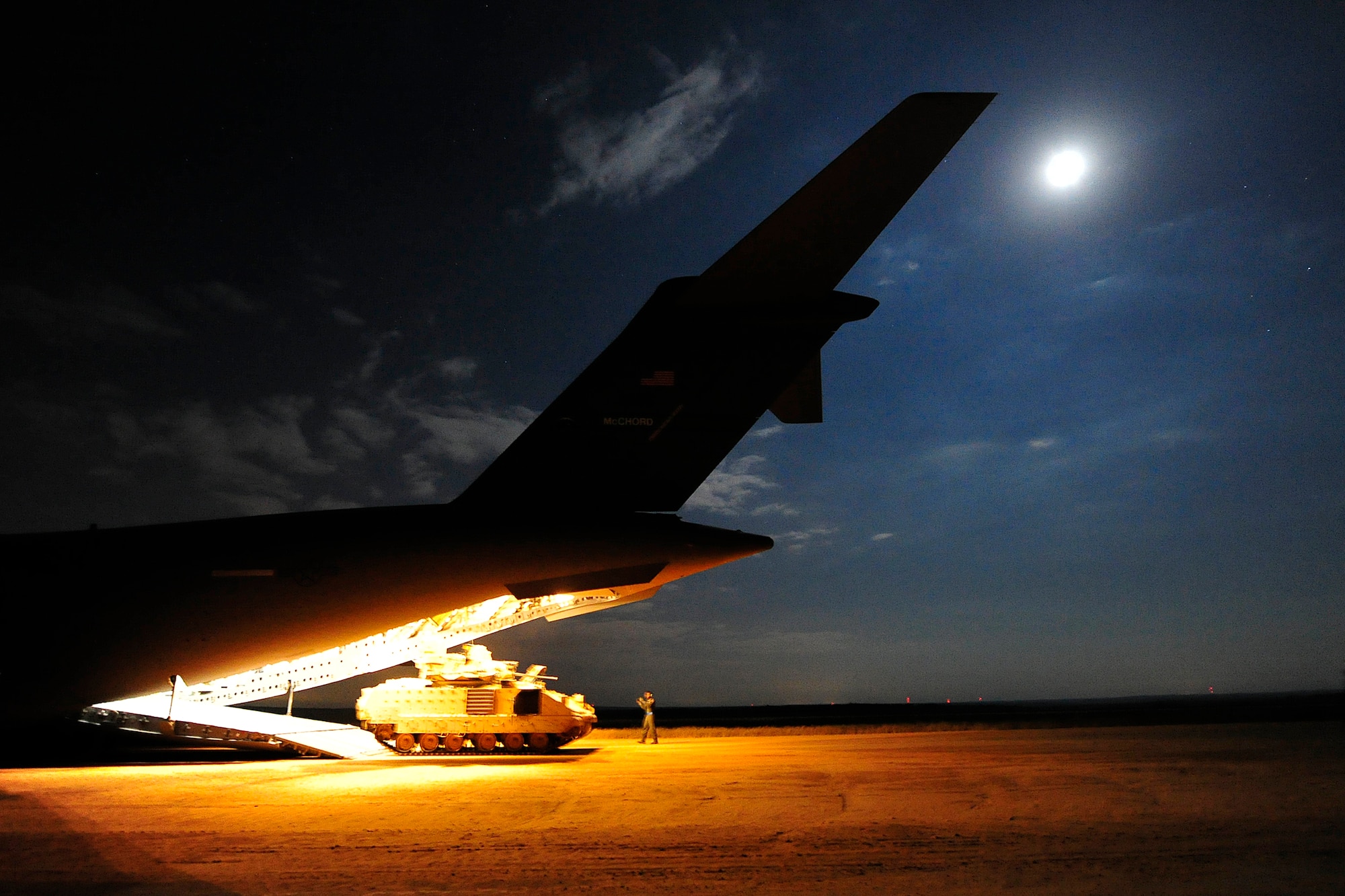 A C-17 Globemaster III offloads a U.S. Army M2A1 Bradley Infantry Fighting Vehicle at Holland Landing Zone, Fort Bragg, N.C., during Joint Operations Access Exercise 12-02, June 7. JOAX is a two-week forcible entry and ground combat exercise to prepare Air Force and Army service members to respond to worldwide crises and contingencies. (U.S. Air Force photo by Tech. Sgt. Parker Gyokeres)
