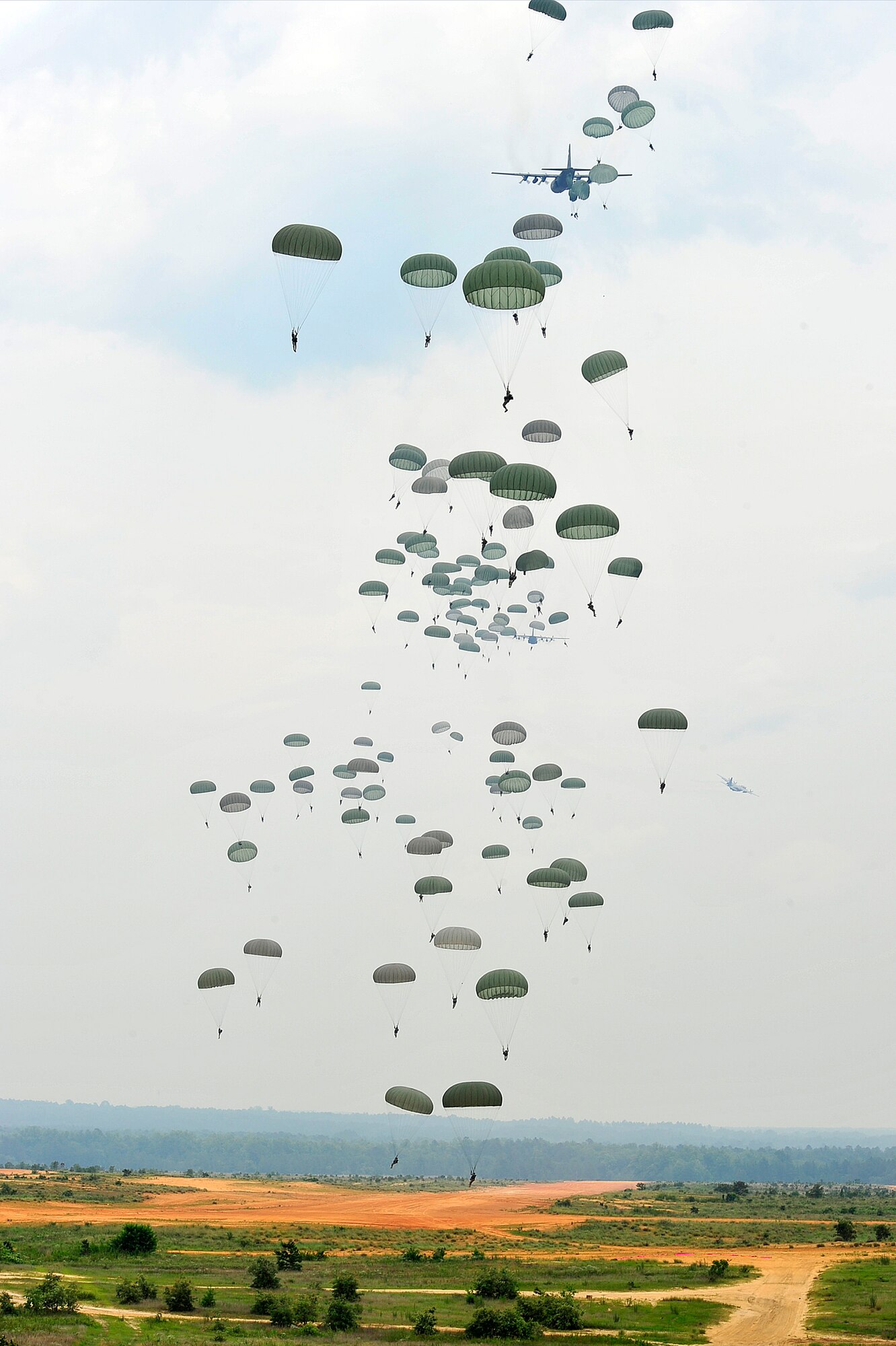 A C-130 Hercules drops U.S. Army paratroopers of the 82nd Airborne Division onto Luzon drop zone during a training mission prior to Joint Operations Access Exercise 12-02 at Mackall Army Airfield, N.C., June 4. JOAX is a two-week forcible entry and ground combat exercise to prepare Air Force and Army service members to respond to worldwide crises and contingencies. (U.S. Air Force photo by Tech. Sgt. Parker Gyokeres)