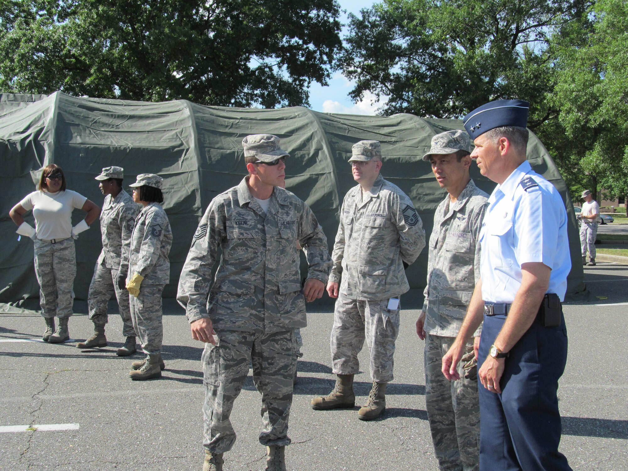 Tech Sgt. Sean P. Keene, medical readiness instructor from Camp Bullis, Texas explains the operation of building a 25-bed field hospital to Col. (Dr.) Rudy Cachuela, 779th Medical Group commander and Maj. Gen. (Dr.) Gerard A. Caron, 79th Medical Wing commander. This week two Expeditionary Medical Support Teams from 779th Medical Group are practicing their ability to build a field hospital to provide emergency response when deployed. Doctors, nurses, medical technicians, logistical assistants, and other support staff are learning how to work together. (AF Photo by Melanie Moore)