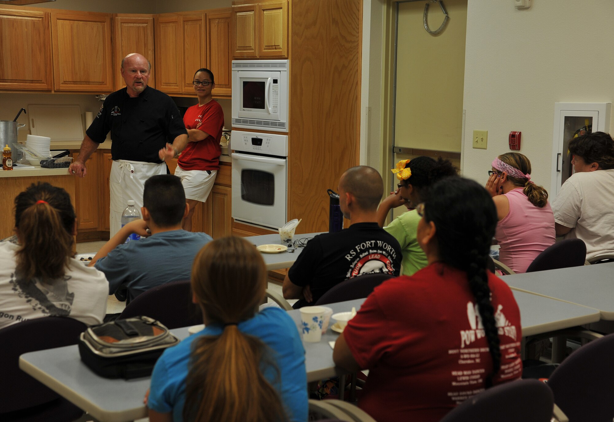 GOODFELLOW AIR FORCE BASE, Texas-- Chef Henry Wiens talks to Team Goodfellow parents and children about examples of healthy food choices during Operation Overall Health June 4th. Operation Overall Health was put together to help inform families on how to live healthy lifestyles. (U.S. Air Force photo/Airman 1st Class Michael Smith) 