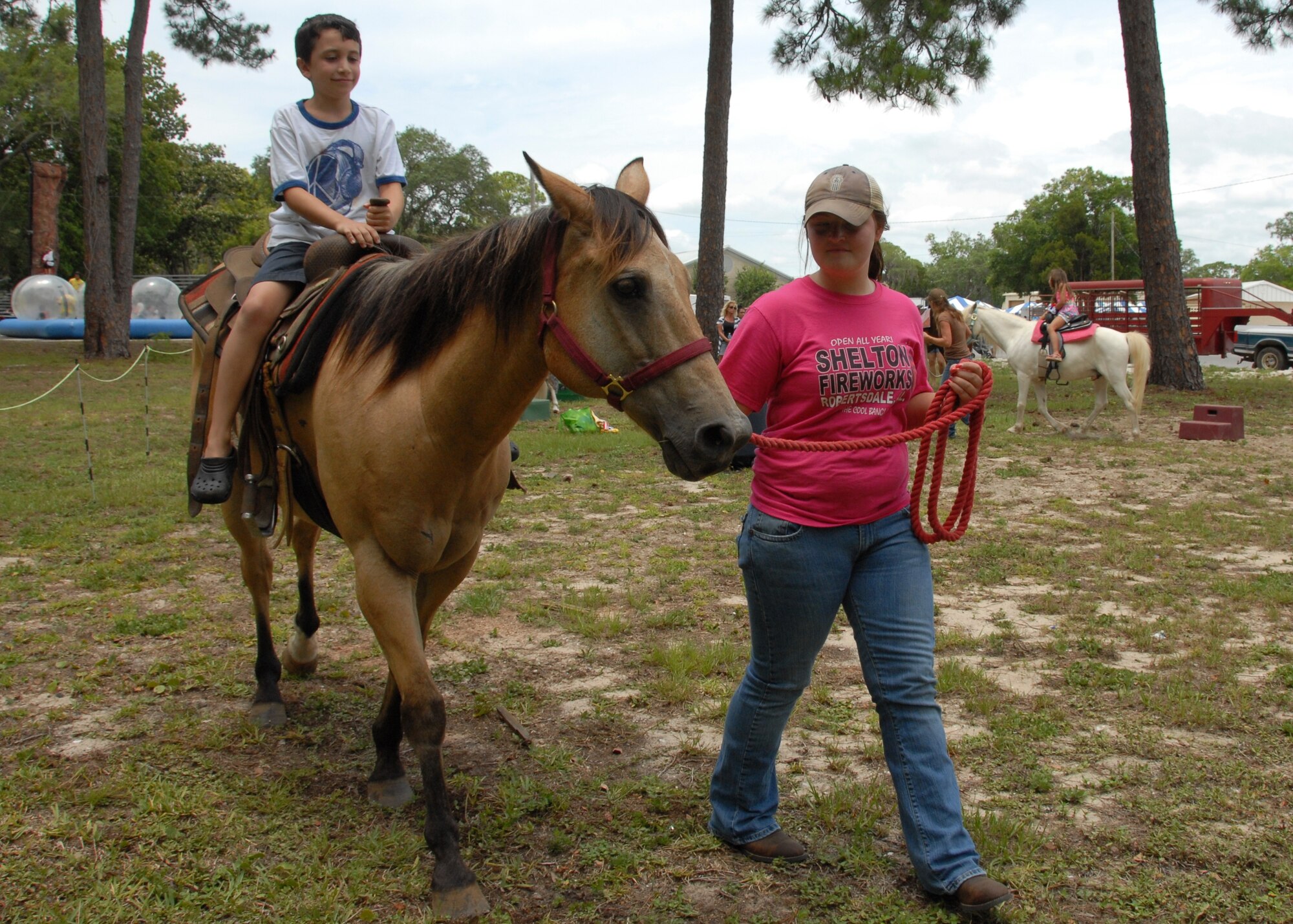 Josh Delamater is led on the horse by Kayla Howell, at the Team Eglin Picnic at Post’l Point June 8. The event featured free food and entertainment for Eglin personnel and families, including a water slide, bouncy house, climbing wall, bungee jumping and horseback riding. (U.S. Air Force photo/Kevin Gaddie)