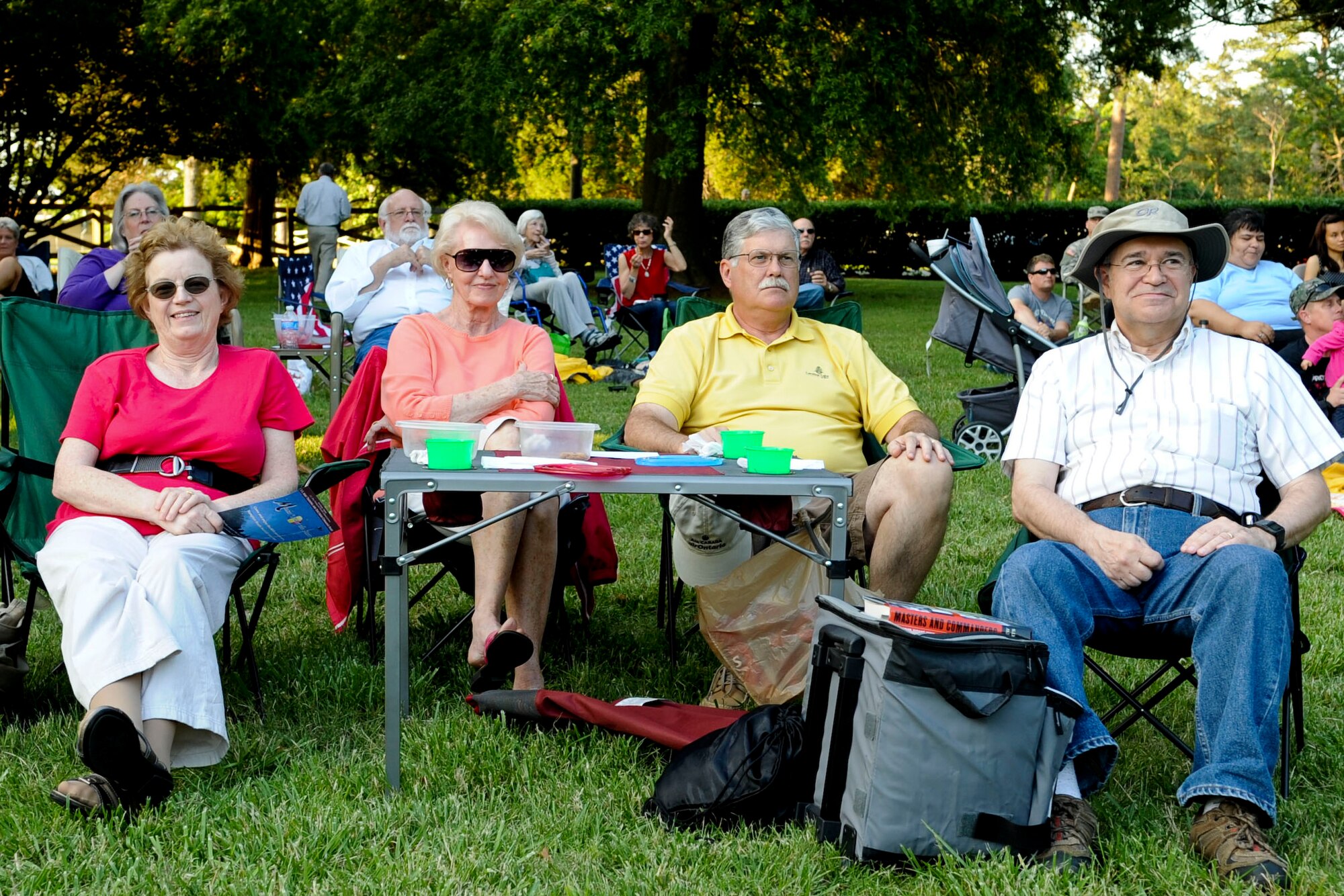 (Left to right) Mary Madden, Wendy McReynolds, Mike McReynolds and Pat Madden enjoy the music of the U.S. Army Training and Doctrine Command Band during the “Music Under the Stars” concert series opener June 7, 2012. The Maddens have attended the event since 1995, and said they “couldn’t pass the chance to bring their friends with them.” (U.S. Air Force photo by Senior Airman Wesley Farnsworth/Released)