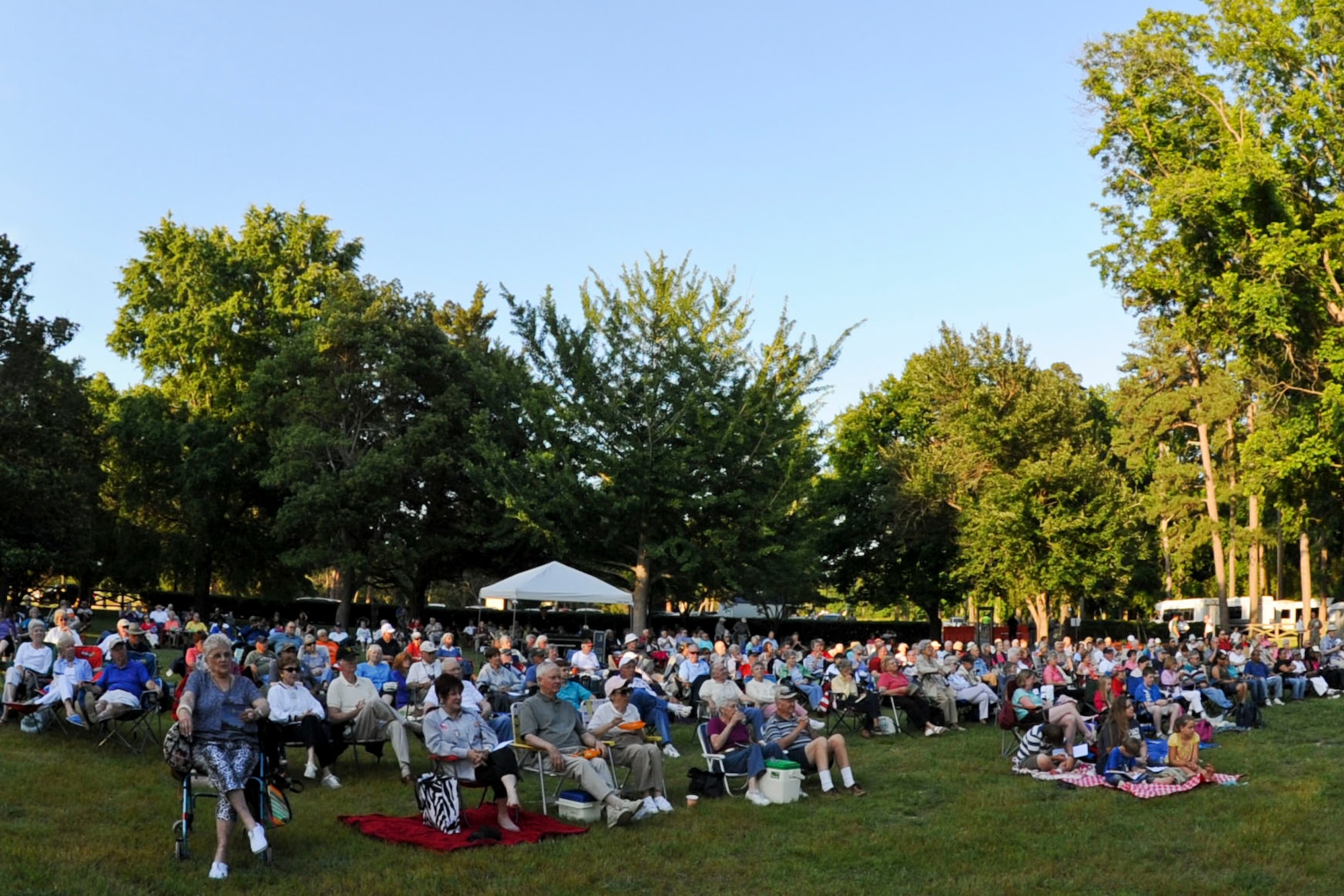 A crowd of 500 fans gather at Ft. Eustis' Magnolia Park to listen to the music of the U.S. Army Training and Doctrine Command Band during the “Music Under the Stars” concert series opener, June 7, 2012. During the performance, the band played more than 10 songs, including “Rolling Thunder” by Henry Fillmore and “Fiesta” by Philip Sparke. (U.S. Air Force photo by Senior Airman Wesley Farnsworth/Released)