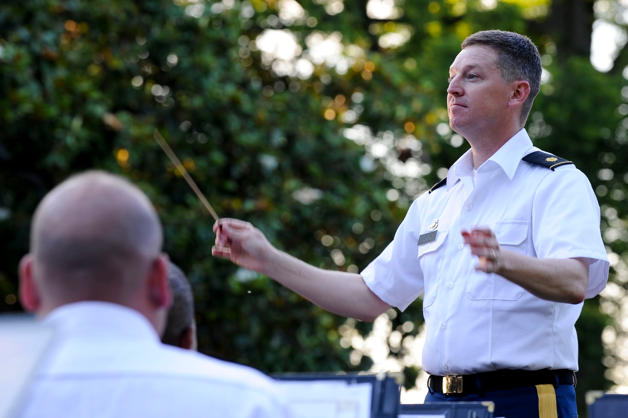 U.S. Army Maj. Scott McKenzie, the U.S. Army Training and Doctrine Command Band commander and conductor, leads the band during the “Music Under the Stars” concert series opener at Ft. Eustis' Magnolia Park, June 7, 2012. During the performance, the band played more than 10 songs, including “King Cotton” by J.P. Sousa and Lee Greenwood's “God Bless the U.S.A.” (U.S. Air Force photo by Senior Airman Wesley Farnsworth/Released)