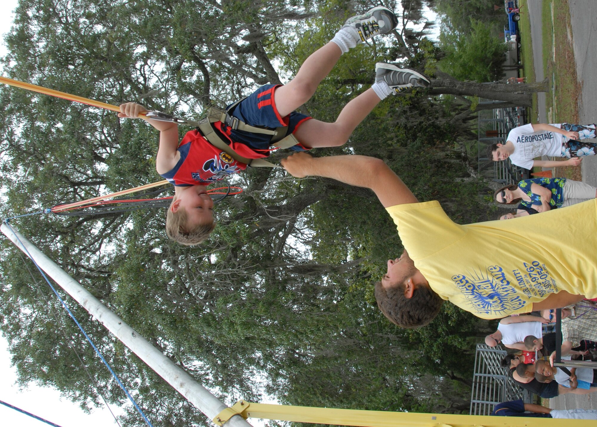 Tyler Smith gets a boost on the bungee jump at the Team Eglin Picnic at Post’l Point June 8.The event featured free food and entertainment for Eglin personnel and families, including a water slide, bouncy house, climbing wall, bungee jumping and horseback riding. (U.S. Air Force photo/Kevin Gaddie)