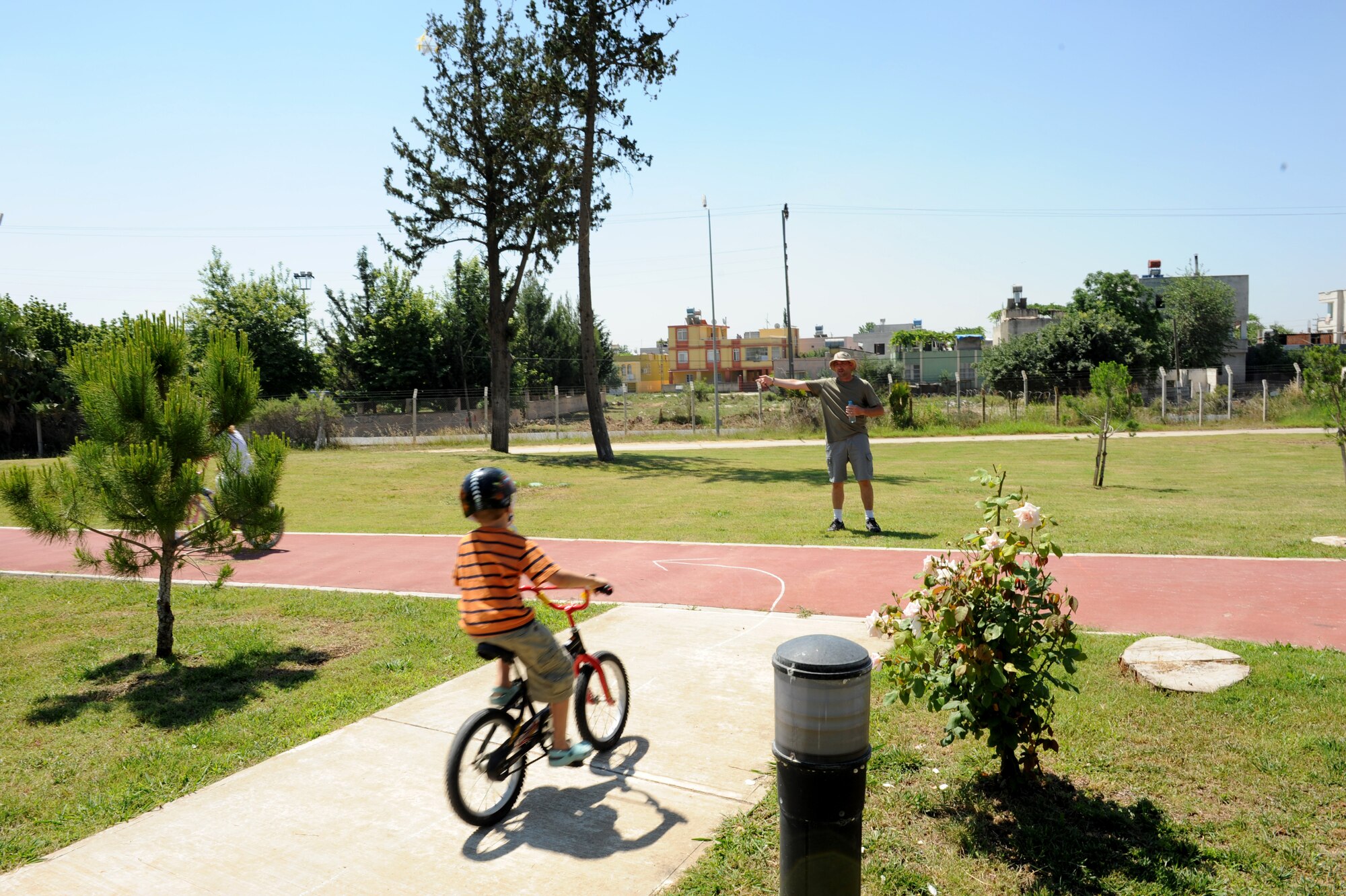 Tech. Sgt. Brian Stanford, 39th Maintenance Squadron, directs a bicycle rider on an obstacle course during a Bicycle Safety Rodeo June 9, 2012 at Incirlik Air Base, Turkey. The annual event is designed to inform riders of all ages about proper safety techniques to use while riding a bicycle. (U.S. Air Force photo by Senior Airman Jarvie Z. Wallace/Released)