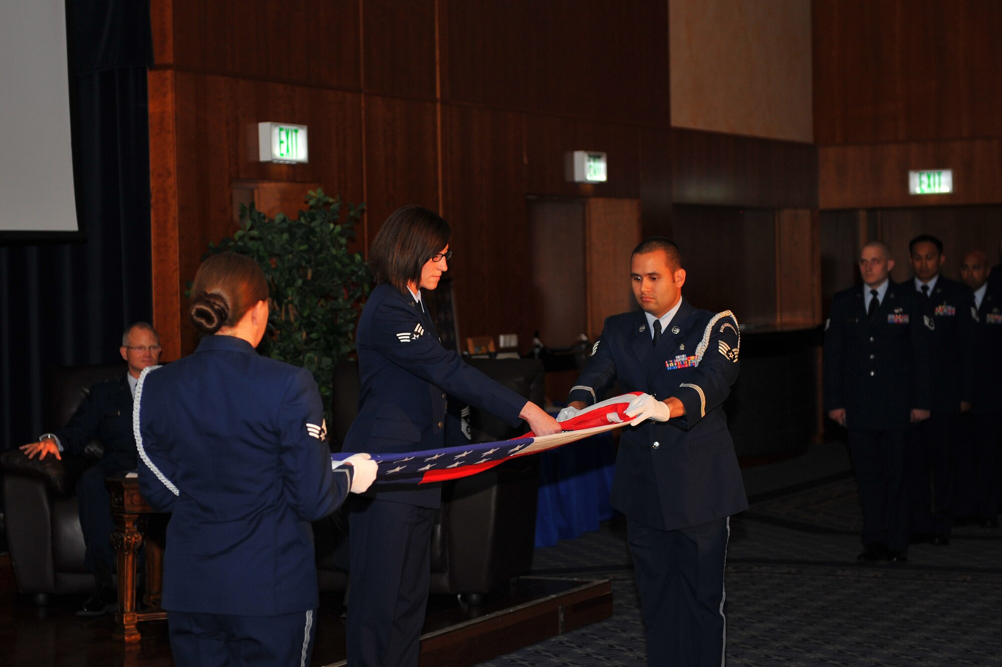 SPANGDAHLEM AIR BASE, Germany – Members of the 52nd Fighter Wing Honor Guard, along with Airmen from throughout the 52nd FW, perform a flag folding ceremony for Chief Master Sgt. Sandra Miller, 52nd FW command chief, during Miller’s retirement ceremony inside the Club Eifel ballroom here June 8. Miller retired after 29 years of service and more than 150 people attended the ceremony to celebrate her transition into civilian life. (U.S. Air Force photo by Airman 1st Class Dillon Davis/Released)