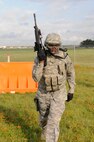Airman 1st Class Carl Martin, 902nd Security Forces Squadron installation police officer, walks  with his M-4 assault rifle during Shoot, Move and Communicate training at Camp Talon on Joint Base San Antonio- Randolph, June 7.  (U.S. Air Force Photo by Don Lindsey)