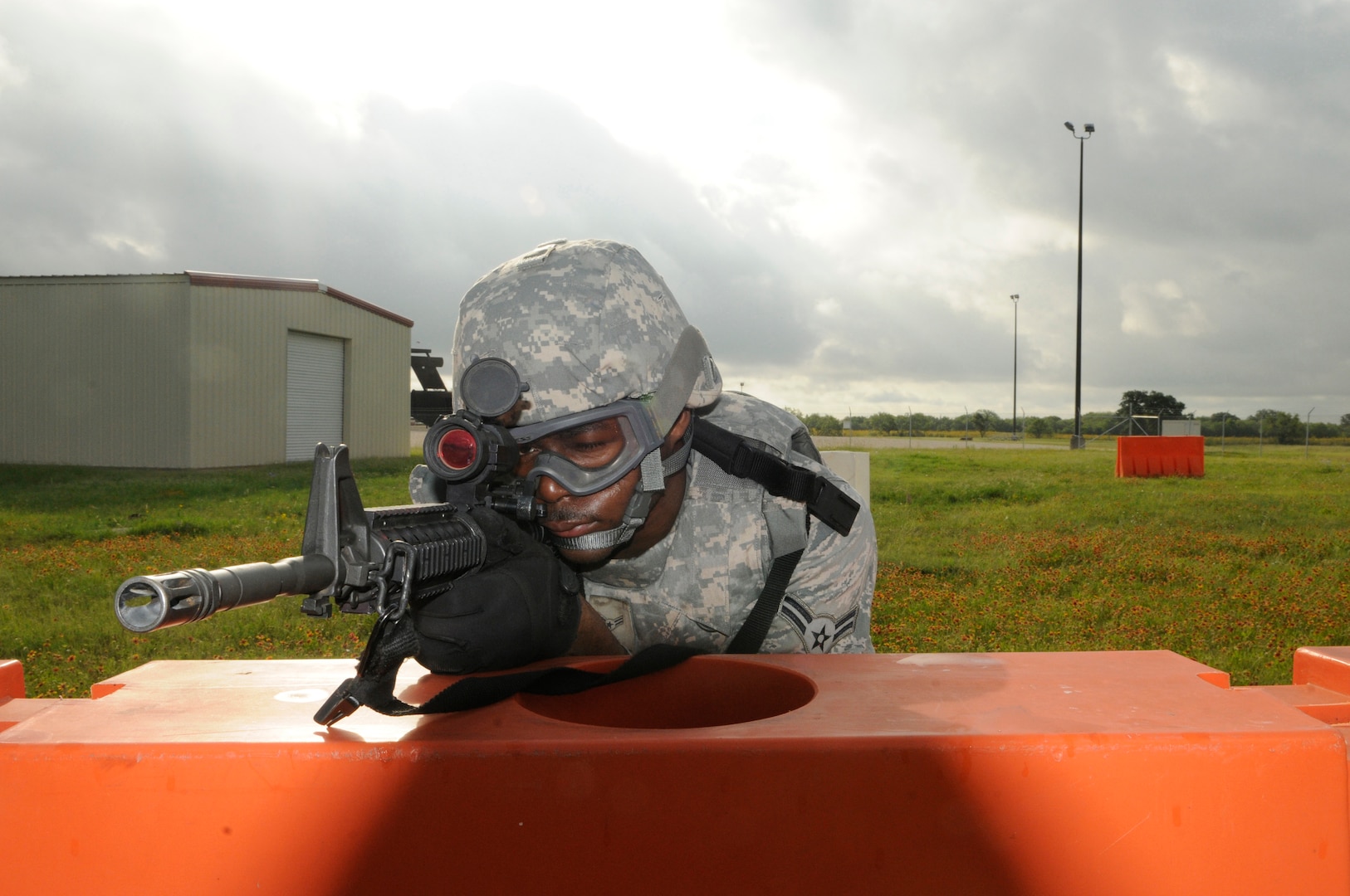 Airman 1st Class Carl Martin, 902nd Security Forces Squadron installation police officer, keeps his eye on the target during Shoot, Move and Communicate training at Camp Talon on Joint Base San Antonio- Randolph, June 7.  (U.S. Air Force Photo by Don Lindsey)
