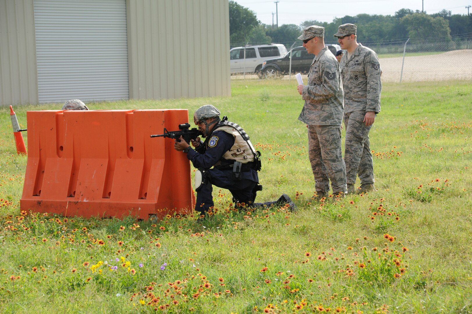 Instructors from the  902nd Security Forces Squadron provide guidance to officer Agapito Delarosa, 902nd SFS installation patrolman as he  prepares to shoot at his target  during Shoot, Move and Communicate training at Camp Talon on Joint Base San Antonio- Randolph, June 7.  (U.S. Air Force Photo by Don Lindsey)
Airman 1st Class Carl Martin, 902nd Security Forces Squadron, installation police officer fires his M-4 assault rifle at his target during Shoot, Move and Communicate training at Camp Talon on Joint Base San Antonio- Randolph, June 7.  (U.S. Air Force Photo by Don Lindsey)
