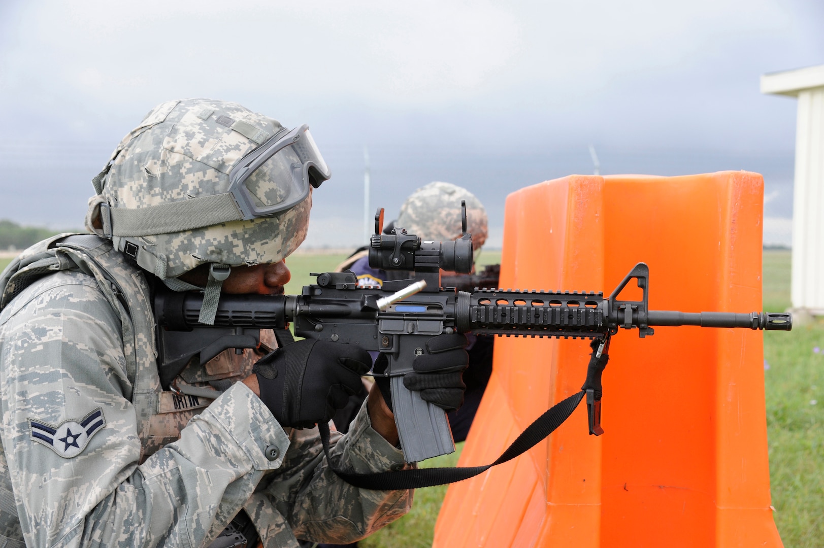 Airman 1st Class Carl Martin, 902nd Security Forces Squadron, installation police officer fires his M-4 assault rifle at his target during Shoot, Move and Communicate training at Camp Talon on Joint Base San Antonio- Randolph, June 7.  (U.S. Air Force Photo by Don Lindsey)