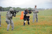 Technical Sergeant Hartman,  902nd training NCOIC Security Forces Squadron looks on as Airman 1st Class Martin and Officer Agapito Delarosa begin their training during Shoot, Move and Communicate training at Camp Talon on Joint Base San Antonio- Randolph, June 7.  (U.S. Air Force Photo by Don Lindsey)