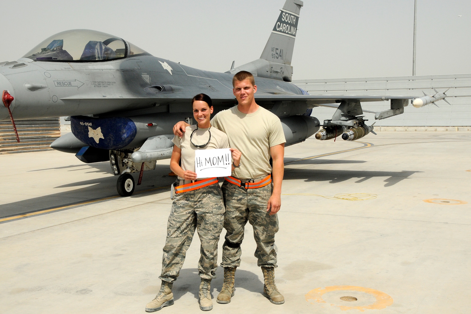 Technical Sgt. Caycee Cook, a public affairs photographer assigned to the 157th Expeditionary Fighter Squadron and her brother Senior Airman Chance Watson, an avionics technician assigned to the 451st Expeditionary Aircraft Maintenance Squadron at Kandahar Airfield, Afghanistan, pose for a photo in front of an F-16 Fighting Falcon May 10, 2012. Personnel are deployed from McEntire Joint National Guard Base, S.C., in support of Operation Enduring Freedom. Swamp Fox F-16's, pilots, and support personnel began their Air Expeditionary Force deployment early April to take over flying missions for the air tasking order and provide close air support for troops on the ground in Afghanistan.
(U.S. Air Force photo/MSgt. Chris Smoak)
