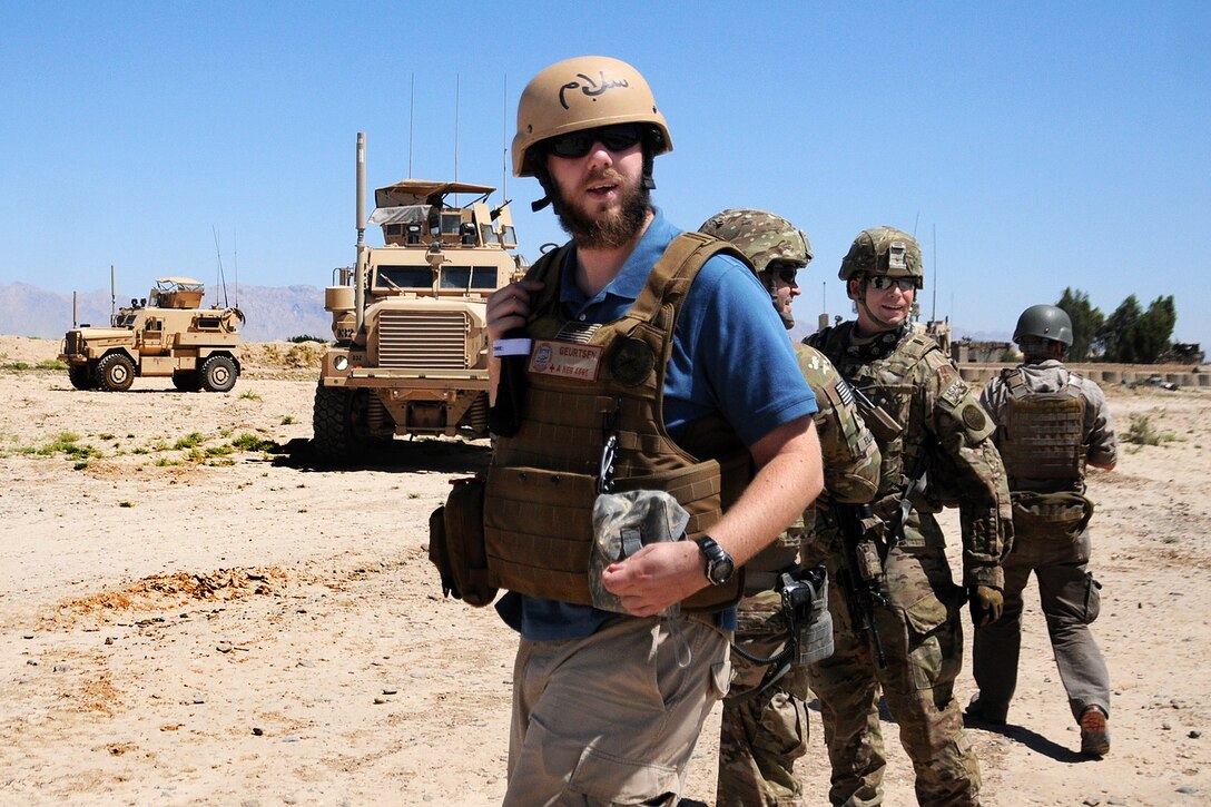Christopher Geurtsen, a field program officer for the U.S. Agency for International Development and members of Provincial Reconstruction Team Farah, arrive for a key leader engagement in Cin Farsi Village in Afghanistan's Farah province, June 9, 2012.