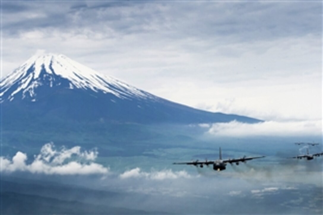 A formation of C-130 Hercules cargo aircraft fly in formation as the crews return from the Samurai Surge training mission near Mount Fuji, Japan, June 5, 2012. At 12,388 feet, Mount Fuji is the tallest mountain in Japan. 