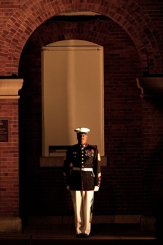 1st Sgt. Auburne Edwards, Company B first sergeant, reports for his unit during a Friday Evening Parade at Marine Barracks Washington June 8.::r::::n::::r::::n::