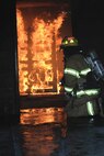 Bob James, a firefighter with the Air Sation's Structural Fire and Emergency Services Department prepares the interior fire for the attack team and works as a safety officer during training.