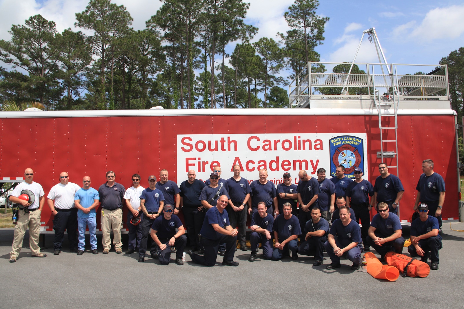 MARINE CORPS AIR STATION BEAUFORT, S.C. - Air Station firefighters and instructors stand next to one of the trailers used in the training exercise April 18 at the Structural Fire Department. The trailer contains a course with various obstacles and small spaces that the firefighters had to maneuver through. 