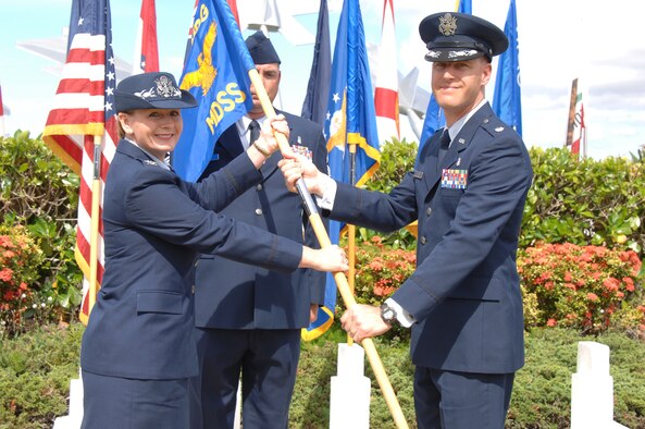Col. Robie Hughes, 15th Medical Group commander, hands the 15th Medical Support Squadron guidon to Lt. Col. Mark Lamey, outgoing 15th Medical Support Squadron commander, during the 15th MDSS Change of Command ceremony June 12 at Joint Base Pearl Harbor-Hickam, Hawaii. The 15th MDSS was constituted on August 25, 1994 and activated on September 15, 1994. (U.S. Air Force photo by Ed Foster)