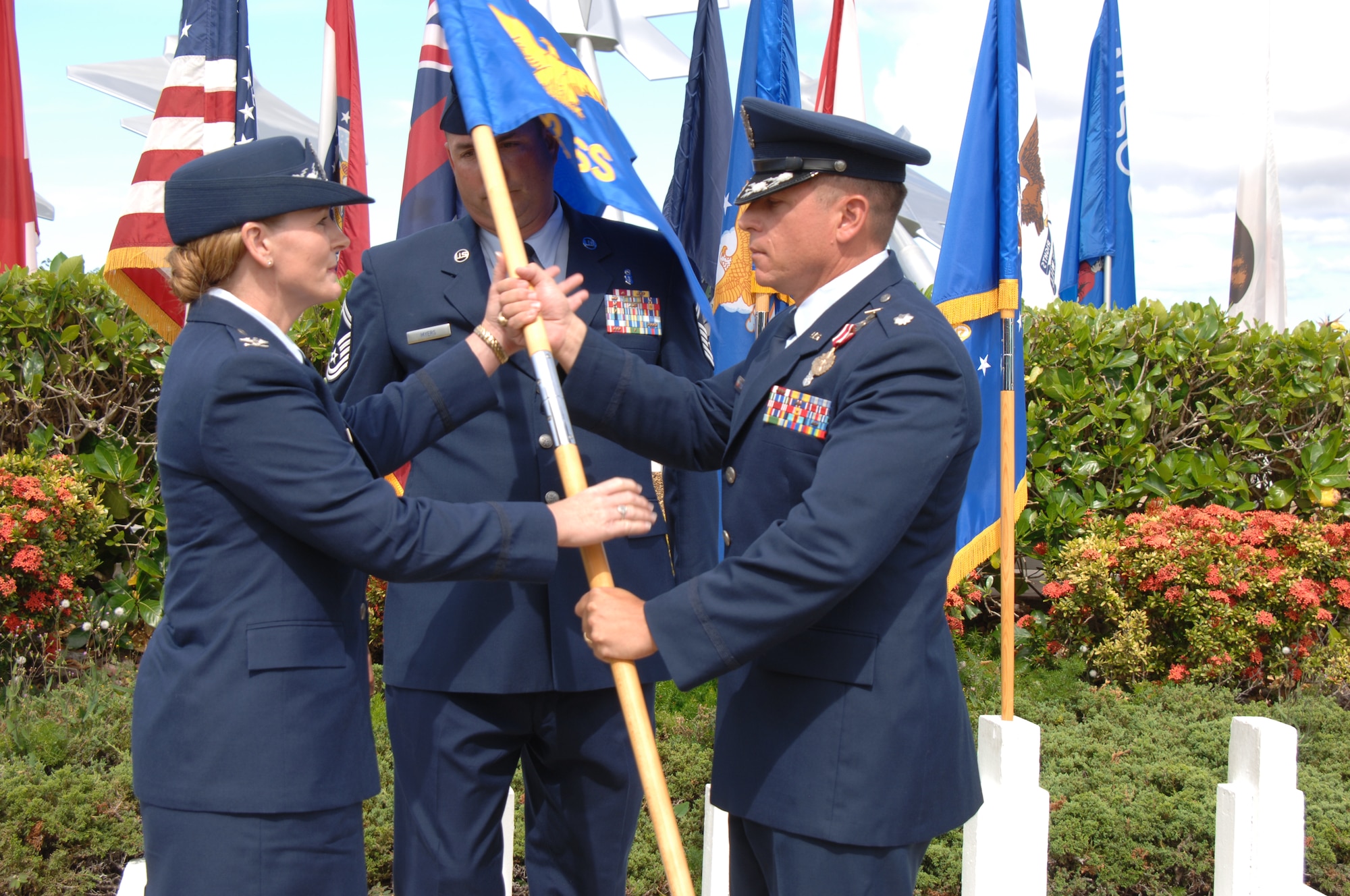 Col. Robie Hughes, 15th Medical Group commander, takes the 15th Medical Support Squadron guidon from Lt. Col. Christopher Dun, outgoing 15th Medical Support Squadron commander, during the 15th MDSS Change of Command ceremony June 12 at Joint Base Pearl Harbor-Hickam, Hawaii. The 15th MDSS was constituted on August 25, 1994 and activated on September 15, 1994. (U.S. Air Force photo by Ed Foster)