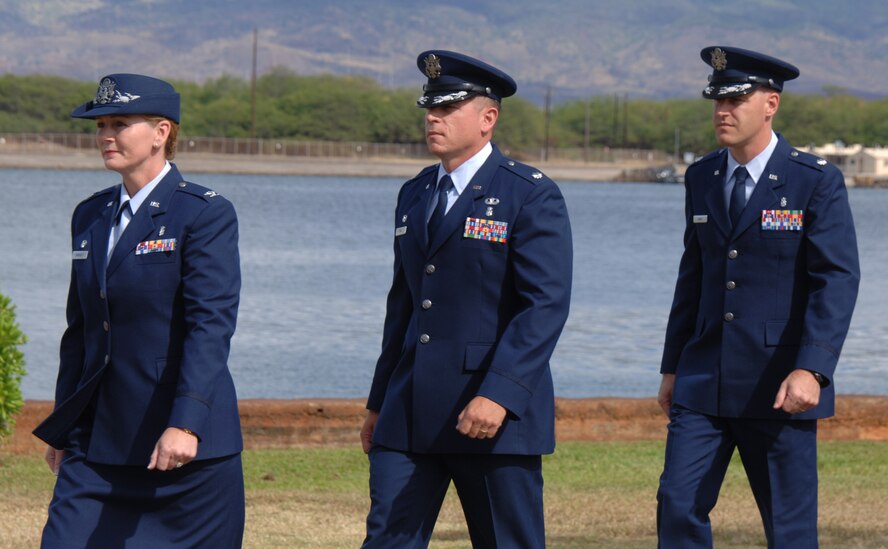 Col. Robie Hughes, 15th Medical Group commander, marches with Lt. Col. Christopher Dun, outgoing 15th Medical Support Squadron commander, and Lt. Col. Mark Lamey, incoming 15th MDSS commander, during the 15th MDSS Change of Command ceremony June 12 at Joint Base Pearl Harbor-Hickam, Hawaii. The 15th MDSS was constituted on August 25, 1994 and activated on September 15, 1994. (U.S. Air Force photo by Ed Foster)