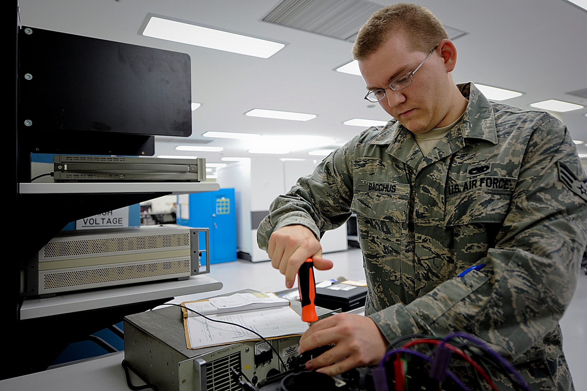 U.S. Air Force Senior Airman Elijah Bacchus, 18th Component Maintenance Squadron technician, performs a scheduled calibration on a machine from Yokota Air Base, Japan, on Kadena AB, Japan, June 12, 2012. The Precision Measurement Equipment Laboratory is in charge of keeping all machinery calibrated on Kadena and also the machinery of 200 other locations throughout the Pacific Air Forces. (U.S. Air Force photo/ Airman 1st Class Brooke P. Beers)