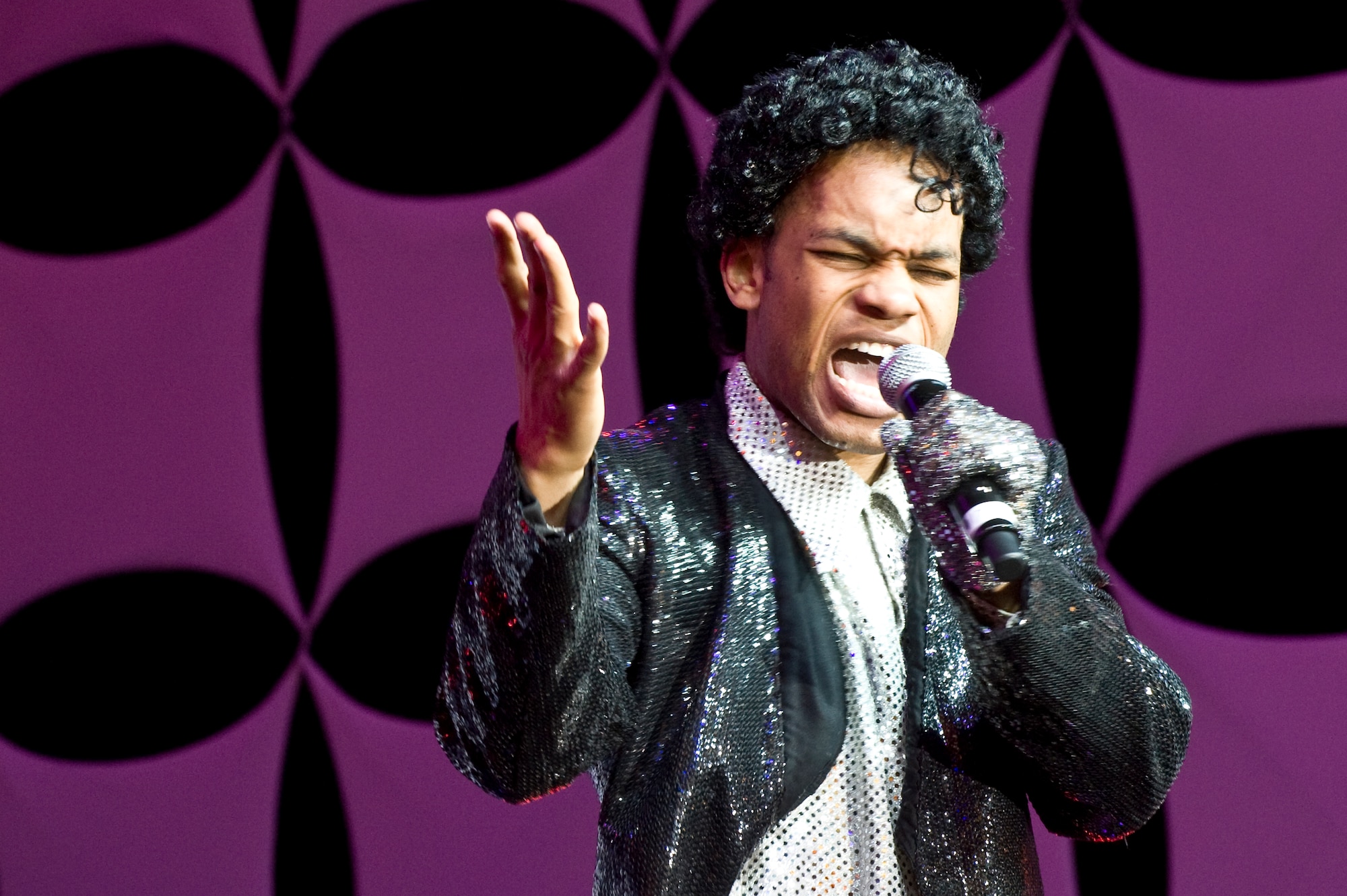 U.S. Air Force Staff Sgt. Tyron Jones, Tops in Blue vocalist, originally from the 374th Operations Support Squadron, Yokota Air Base, Japan, performs during the Tops in Blue 2012 World Tour June 8, 2012, in Las Vegas. Tops In Blue is one of the oldest and most widely-traveled entertainment groups of its kind. (U.S. Air Force photo by Airman 1st Class Matthew Lancaster)